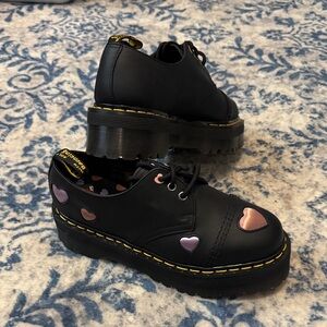 This is a pair of Dr. Martens 1461 Quad Heart platform shoes. NWOT.